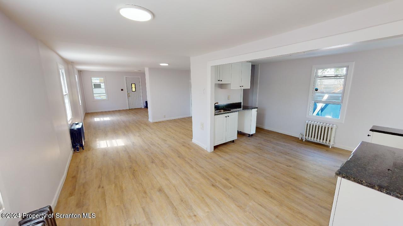400 3rd Street Archbald, PA 18403 - Photo 6 of 15 a view of empty room with wooden floor and window