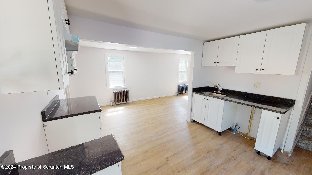 400 3rd Street Archbald, PA 18403 - Photo 7 of 15 a kitchen with granite countertop a stove and a refrigerator