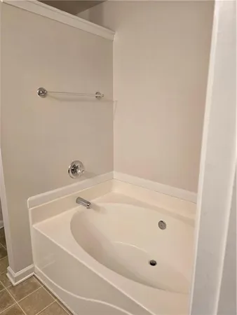a bathroom with a tub and a shower