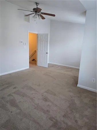 an empty room with a ceiling fan and closet
