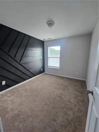 a view of an empty room and a window
