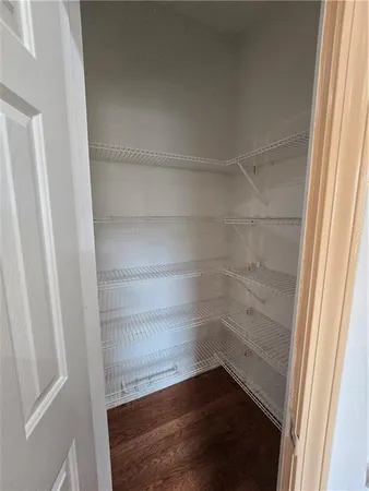 a view of walk in closet with empty racks