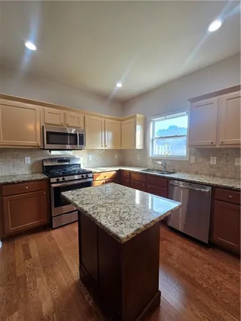 a kitchen with a stove a sink and a microwave
