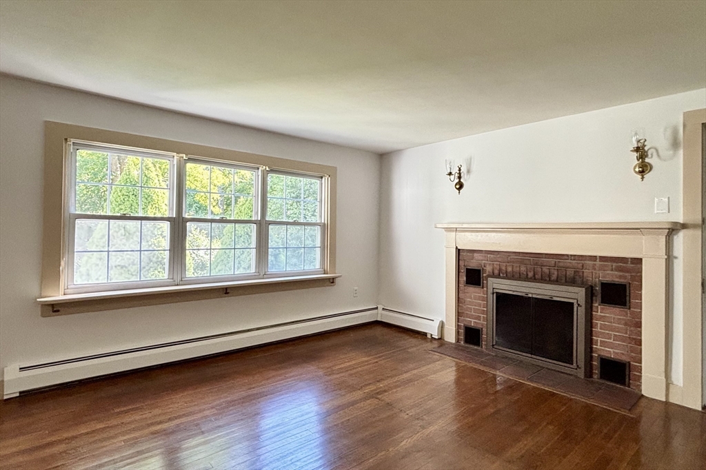 42 New Salem Road Petersham, MA 01366 - Photo 15 of 42 an empty room with wooden floor fireplace and windows