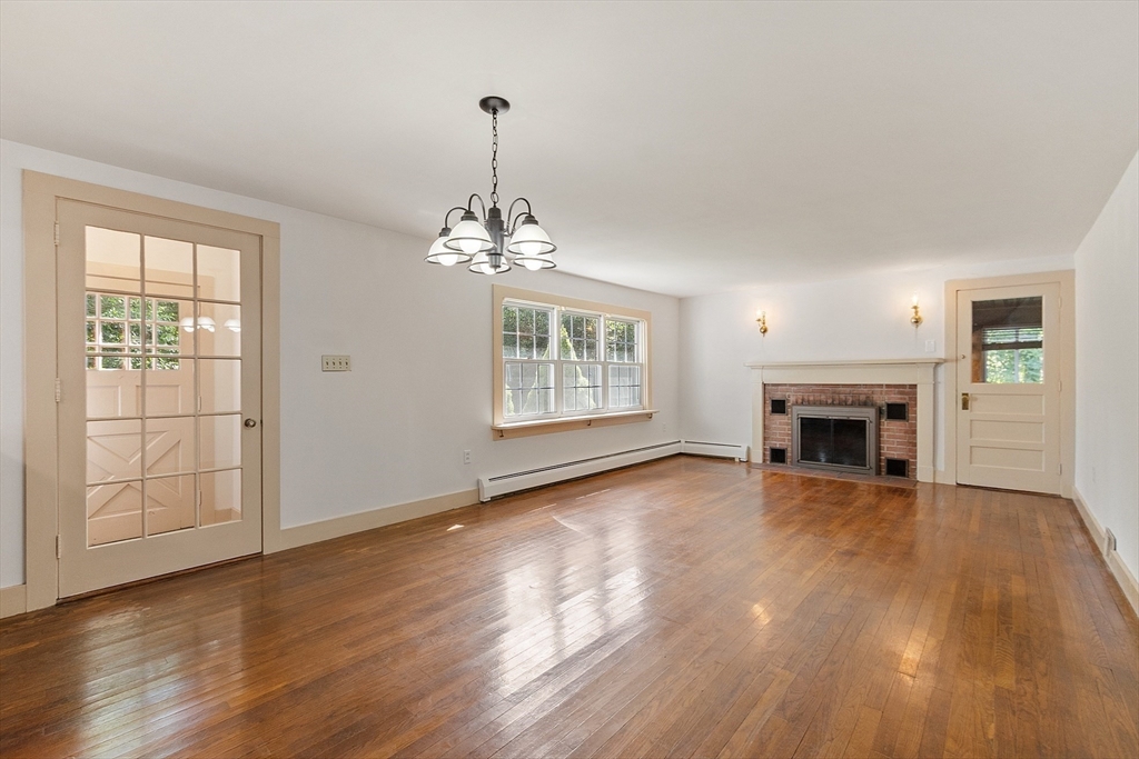 42 New Salem Road Petersham, MA 01366 - Photo 16 of 42 a view of an empty room with wooden floor fireplace and a window