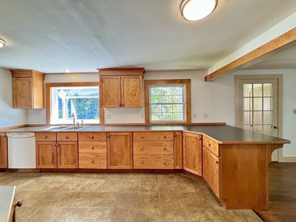 42 New Salem Road Petersham, MA 01366 - Photo 23 of 42 a large kitchen with granite countertop a sink white cabinets and a large window