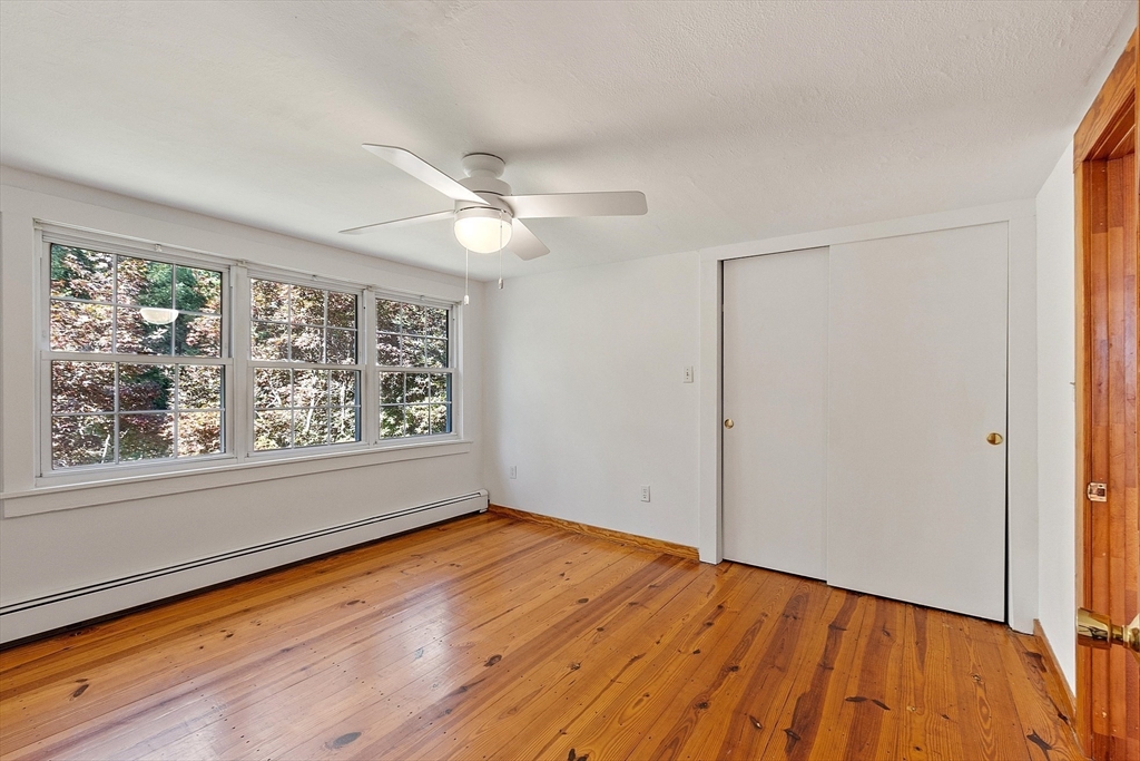 42 New Salem Road Petersham, MA 01366 - Photo 34 of 42 an empty room with wooden floor fan and windows
