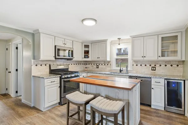 a kitchen with white cabinets and appliances