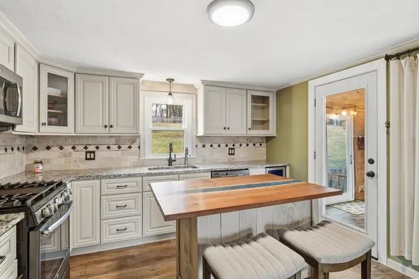 a kitchen with stainless steel appliances a sink and a stove