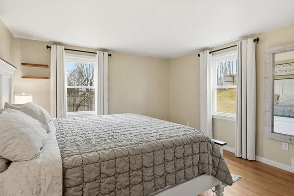 a bedroom with a large bed and a window
