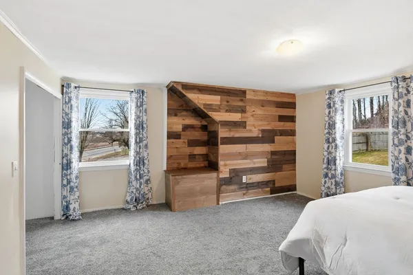 a bedroom with a bed and cabinets
