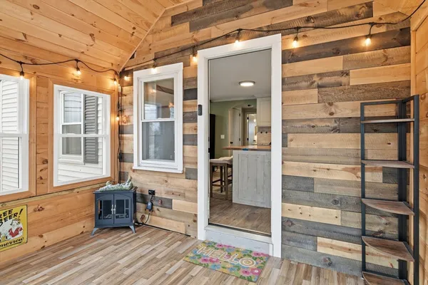 a view of a porch with a table and chairs