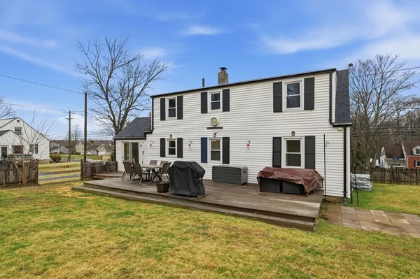 a backyard of a house with fountain fire pit and outdoor seating