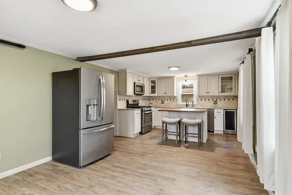 a kitchen with white cabinets and stainless steel appliances