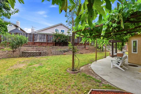 a view of a house with backyard and sitting area