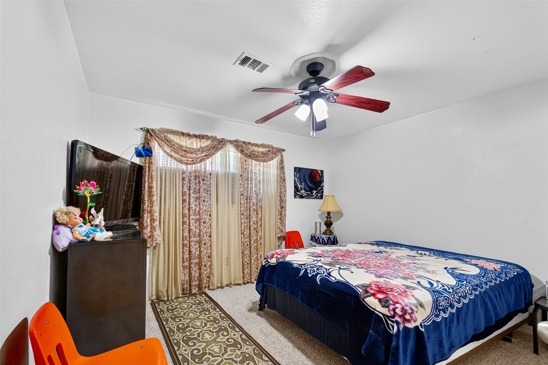 8222 La Roche Lane Houston, TX 77036 - Photo 21 of 32 a bedroom with a bed and a chandelier