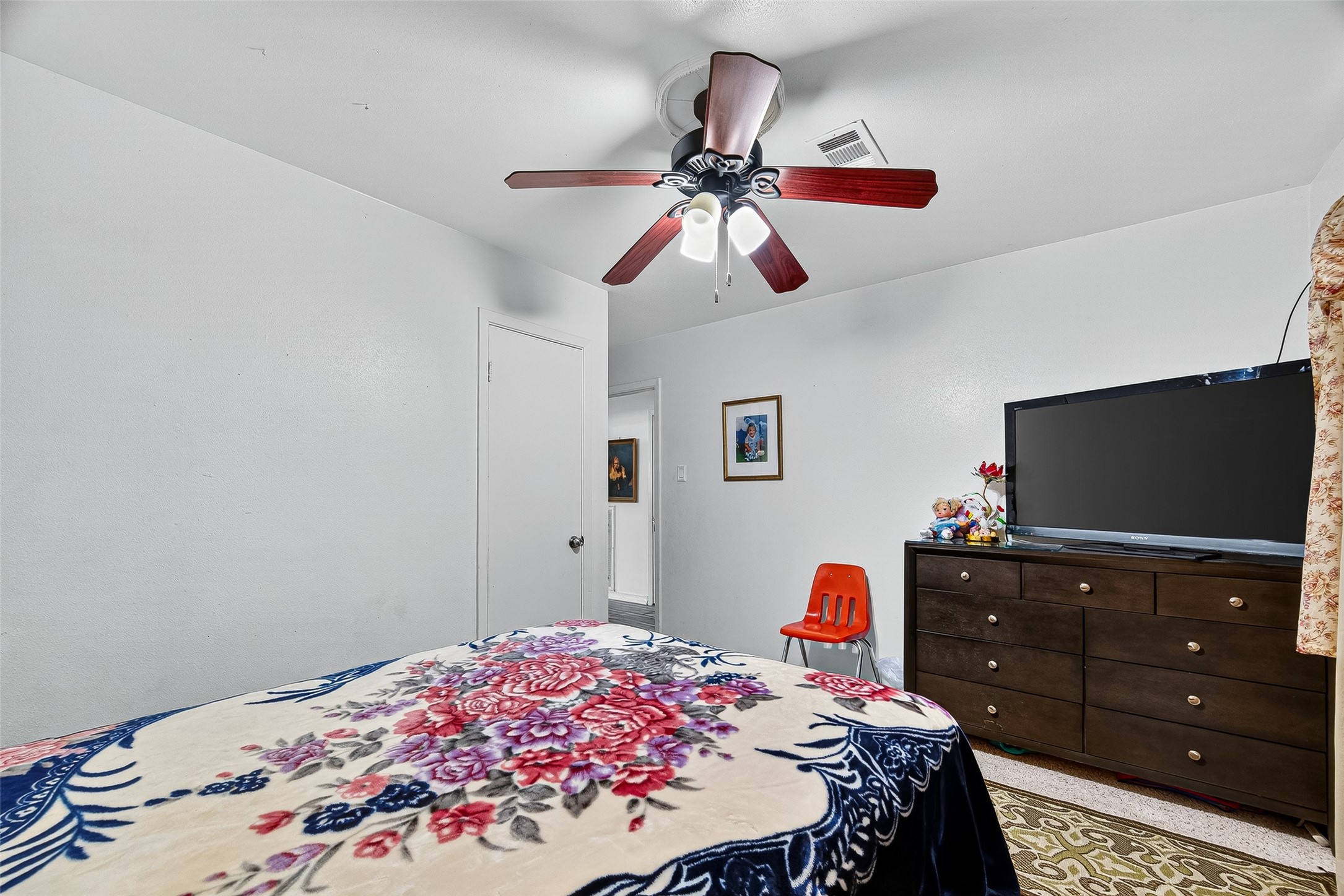 8222 La Roche Lane Houston, TX 77036 - Photo 22 of 32 a bedroom with a bed and a flat screen tv