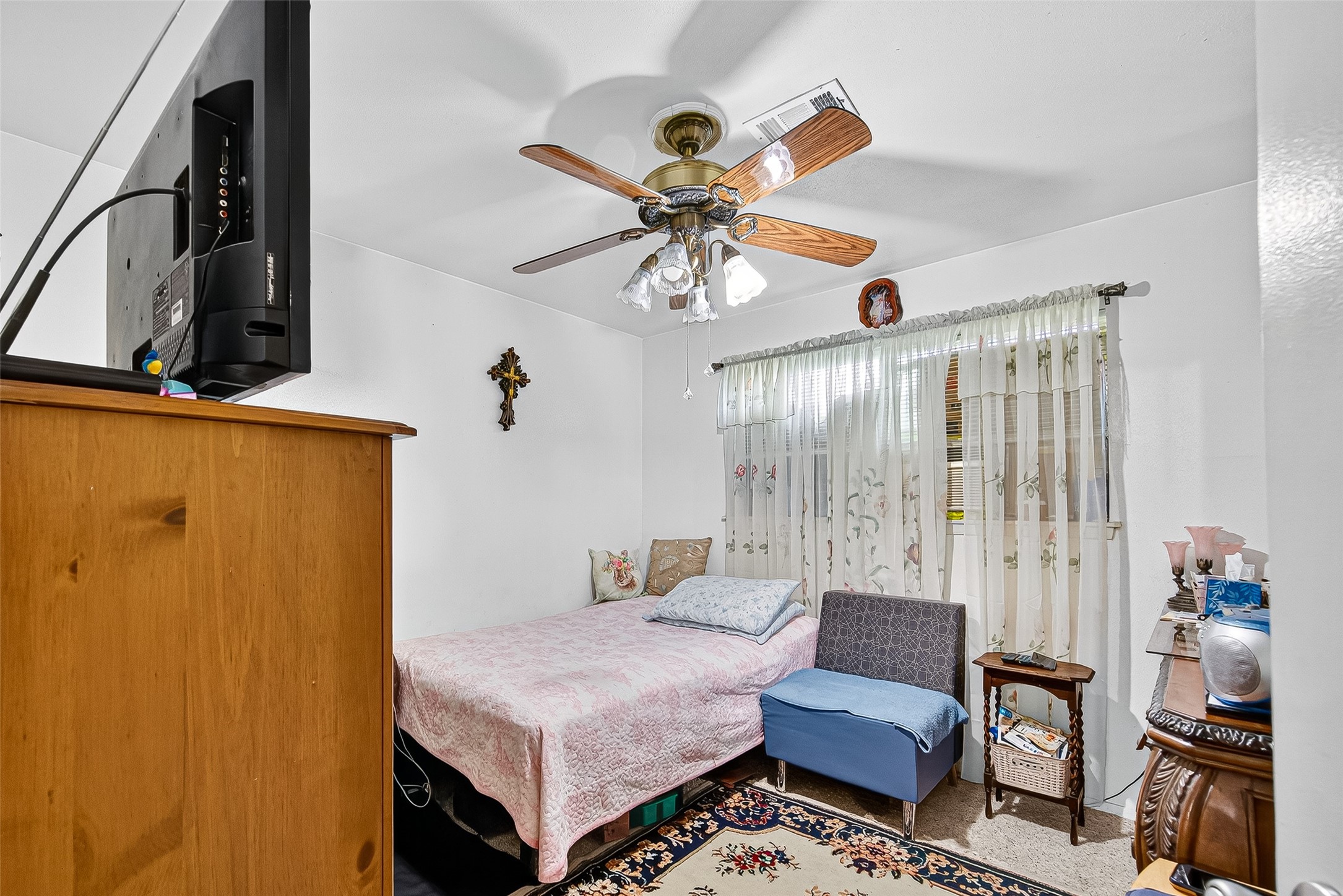 8222 La Roche Lane Houston, TX 77036 - Photo 23 of 32 a bedroom with a bed and a chandelier