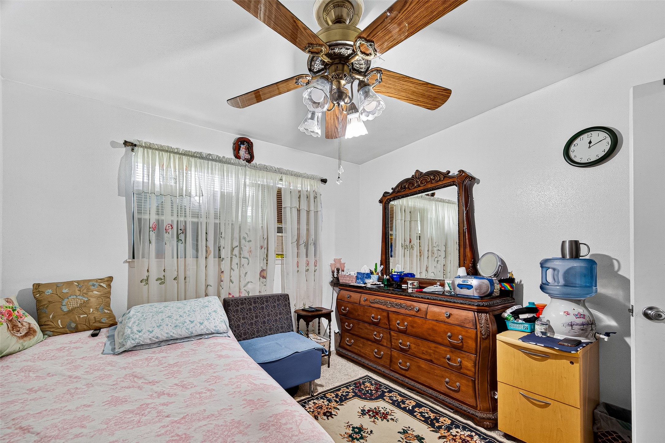 8222 La Roche Lane Houston, TX 77036 - Photo 24 of 32 a bedroom with a bed and a chandelier