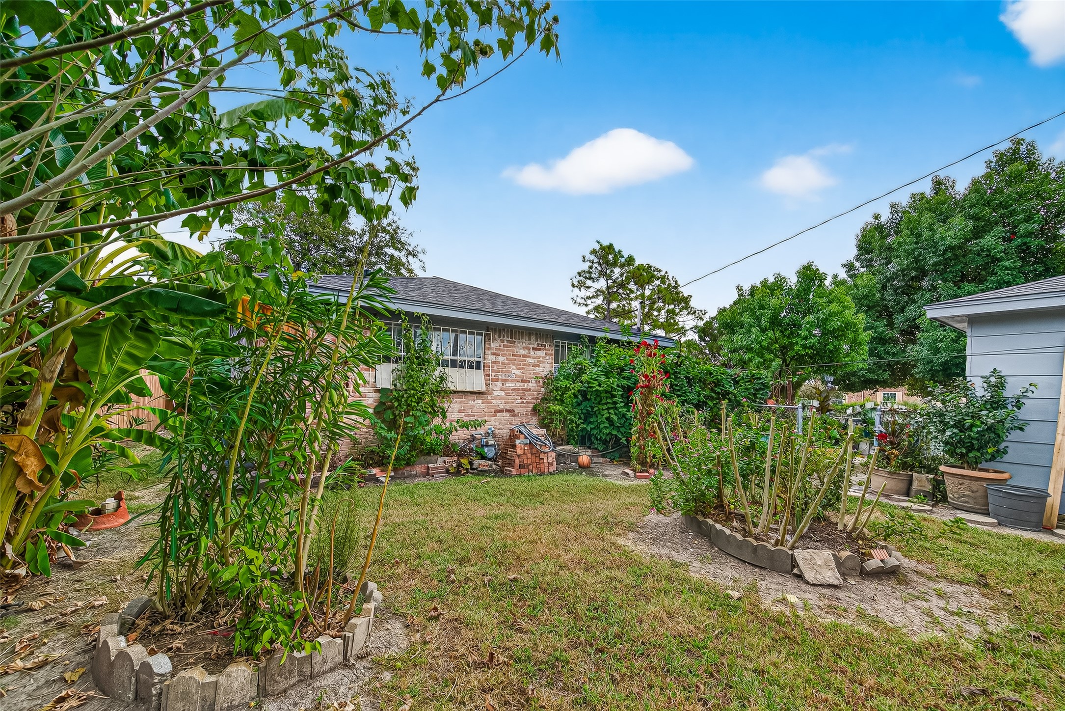 8222 La Roche Lane Houston, TX 77036 - Photo 29 of 32 a view of an house with backyard space and garden