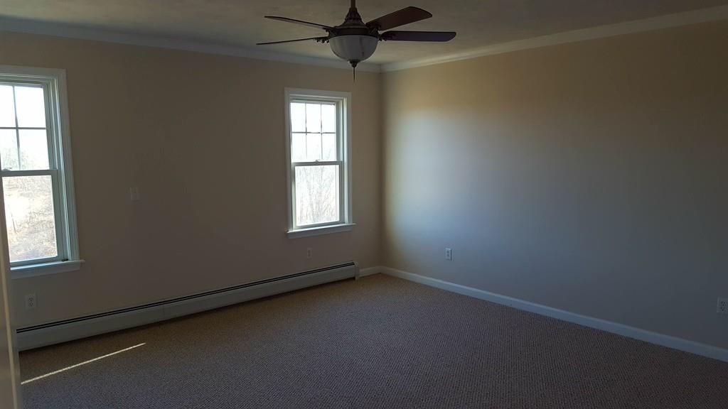 236 Hardwick Road New Braintree, MA 01531 - Photo 13 of 28 an empty room with windows and fan