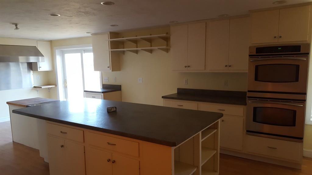 236 Hardwick Road New Braintree, MA 01531 - Photo 20 of 28 a kitchen with kitchen island a counter space and cabinets