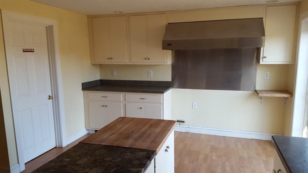 236 Hardwick Road New Braintree, MA 01531 - Photo 22 of 28 a kitchen with granite countertop white cabinets and refrigerator
