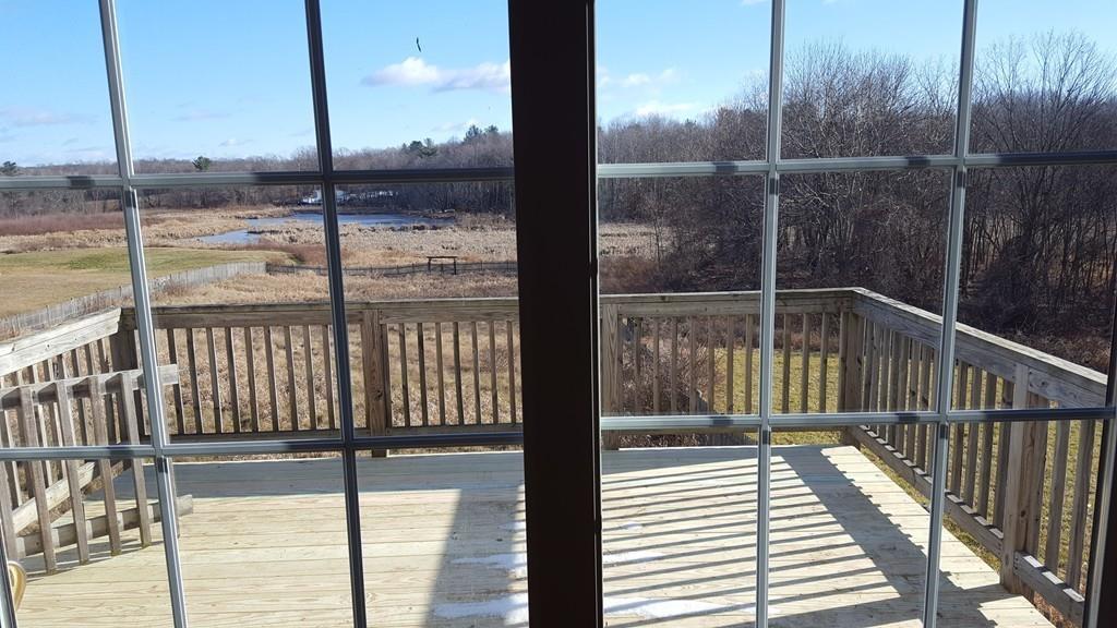 236 Hardwick Road New Braintree, MA 01531 - Photo 7 of 28 a view of a balcony with floor to ceiling window wooden floor