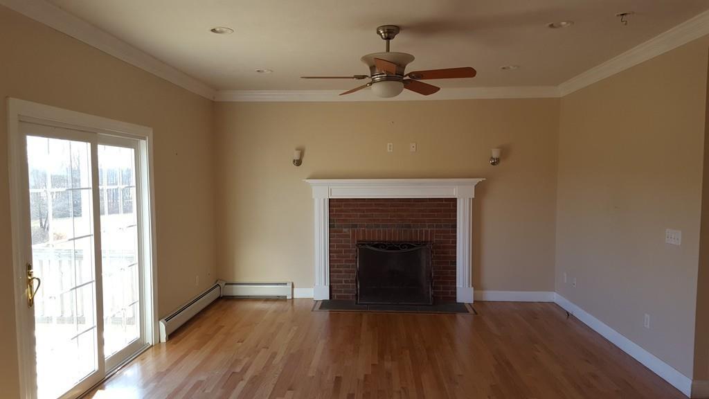 236 Hardwick Road New Braintree, MA 01531 - Photo 8 of 28 a view of an empty room with wooden floor fireplace and a window