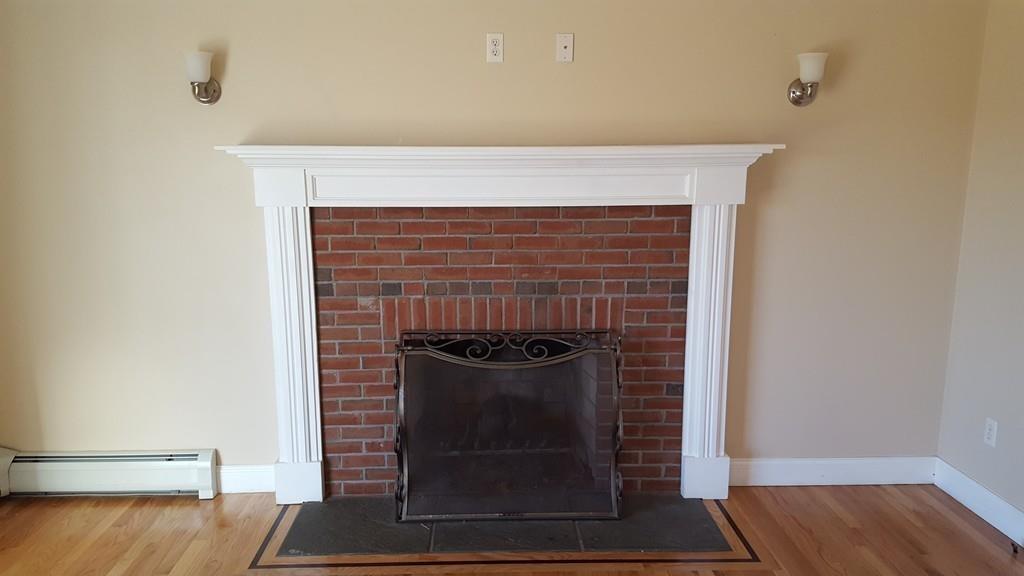 236 Hardwick Road New Braintree, MA 01531 - Photo 9 of 28 a fireplace with a vase on top of it
