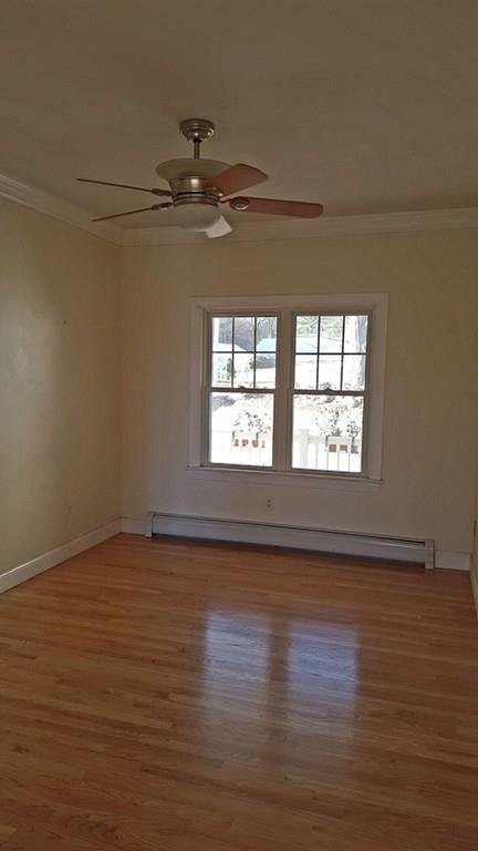 236 Hardwick Road New Braintree, MA 01531 - Photo 10 of 28 an empty room with wooden floor chandelier fan and windows