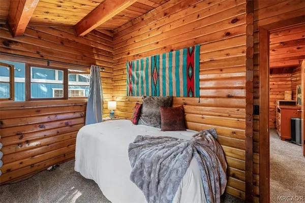 a bed sitting in a bedroom next to a window