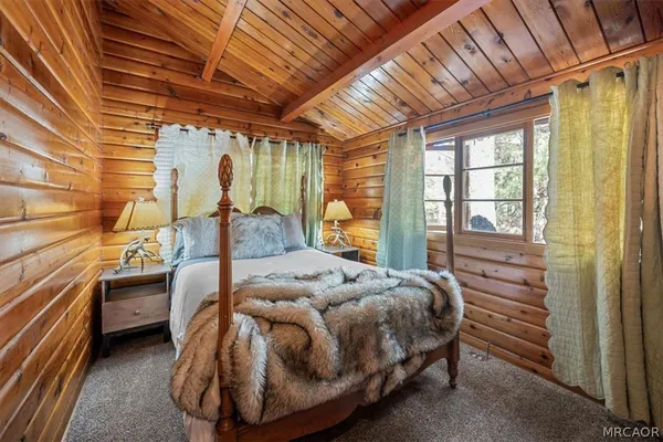 a bed sitting in a bedroom next to a window
