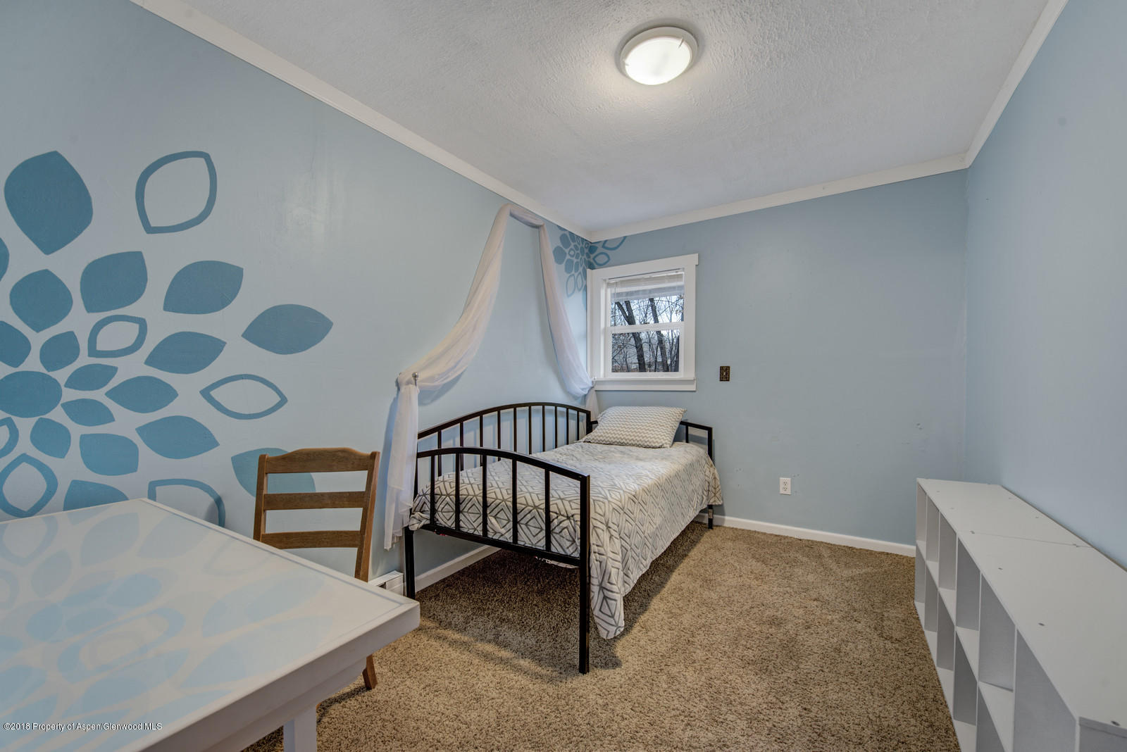 520 Ash Avenue Rifle, CO 81650 - Photo 12 of 21 a bedroom with a bed and a window