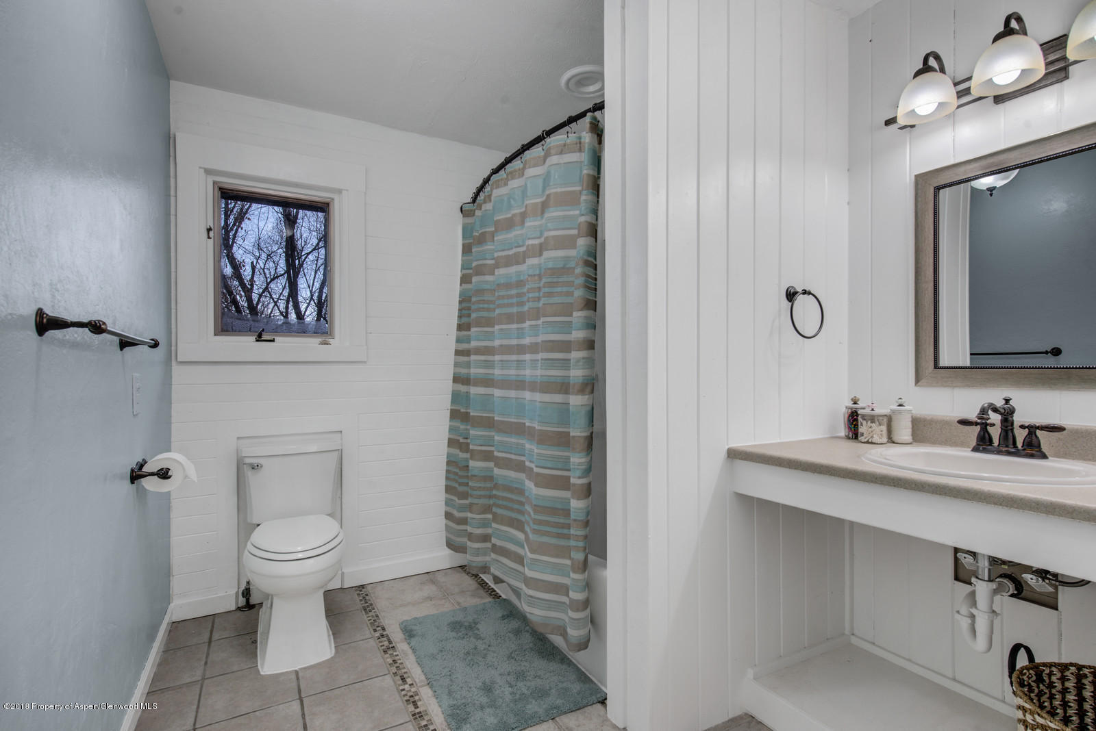 520 Ash Avenue Rifle, CO 81650 - Photo 19 of 21 a bathroom with a toilet a sink and mirror