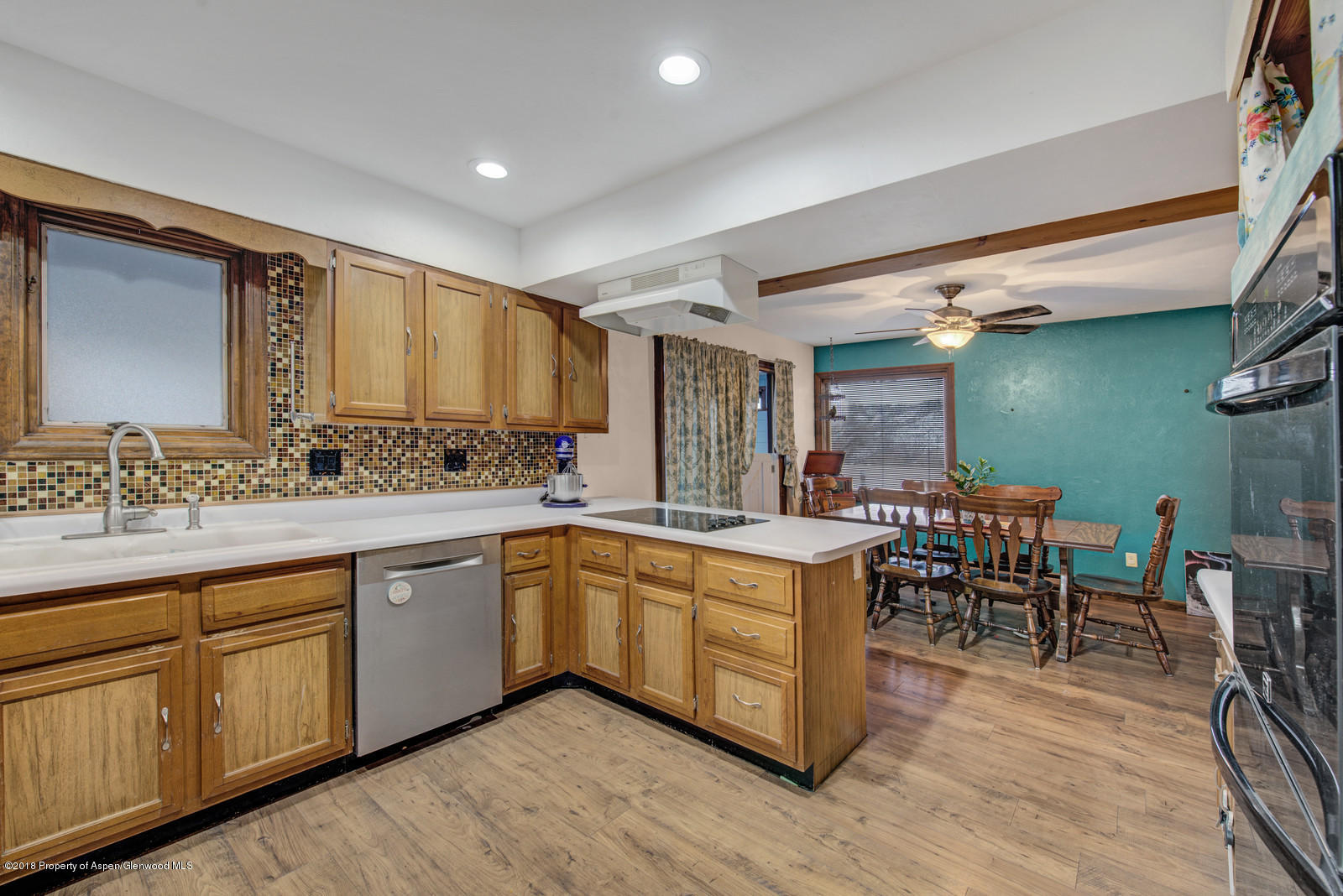 520 Ash Avenue Rifle, CO 81650 - Photo 6 of 21 a large kitchen with cabinets table and chairs
