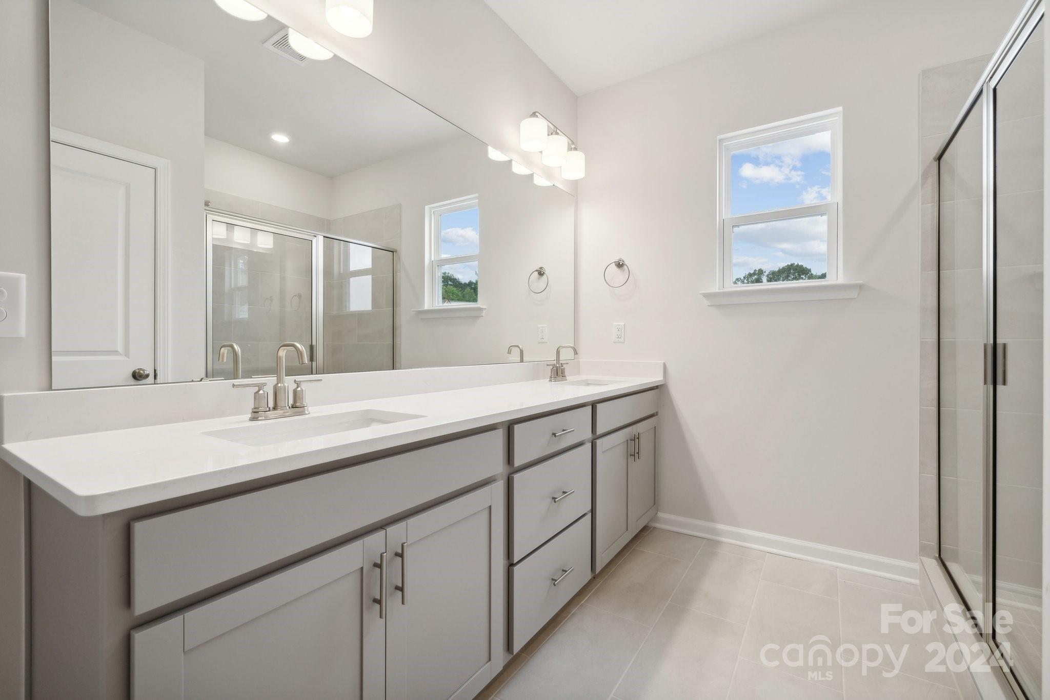 8606 Miles Gap Road Indian Land, SC 29707 - Photo 15 of 26 a bathroom with 2 sink and a mirror