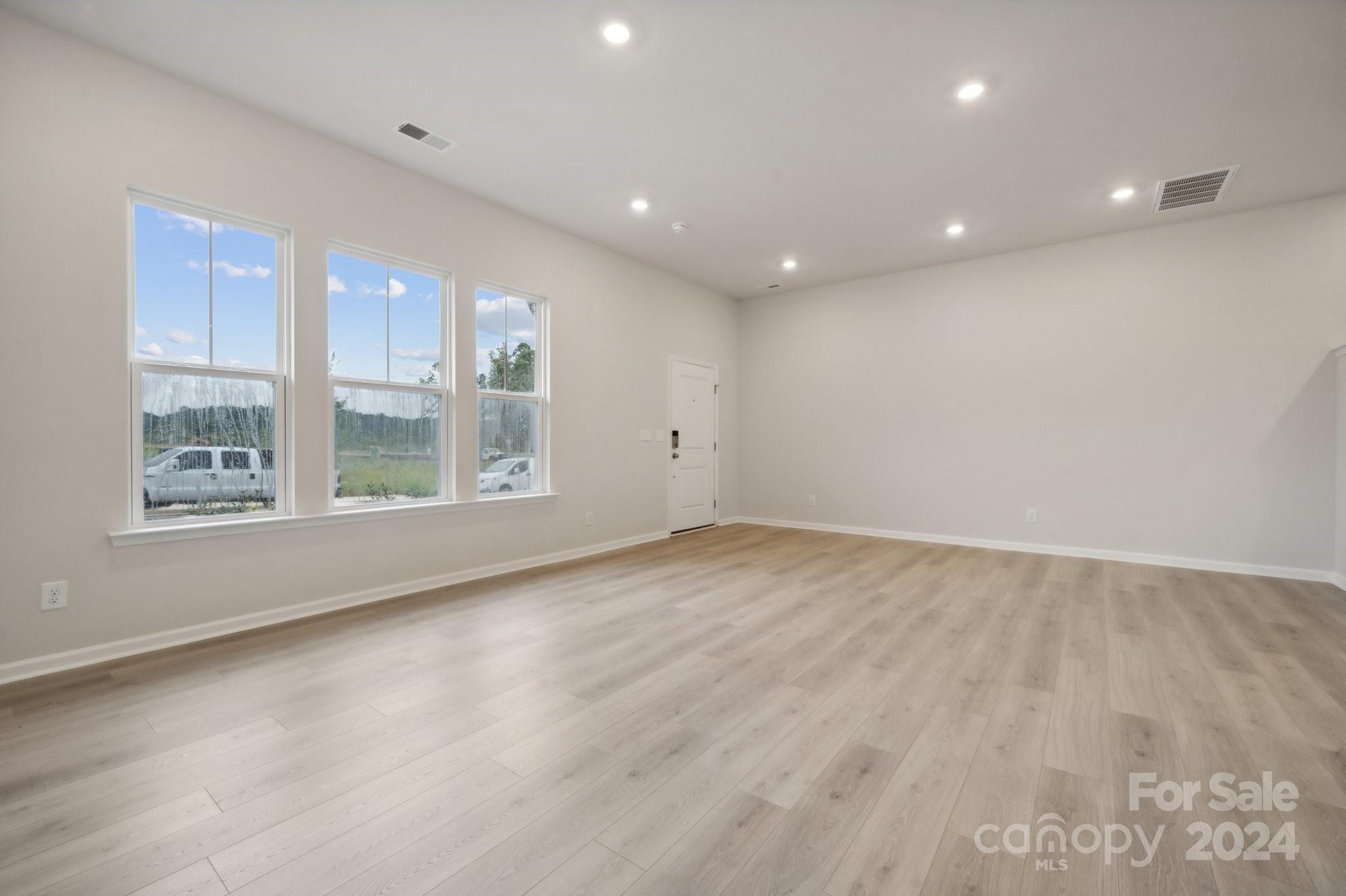 8606 Miles Gap Road Indian Land, SC 29707 - Photo 5 of 26 an empty room with wooden floor and windows