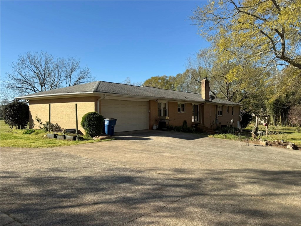 4027 Belhaven Road Belton, SC 29627 - Photo 2 of 24 A classic brick exterior offers enduring appeal with a convenient attached garage and expansive driveway.