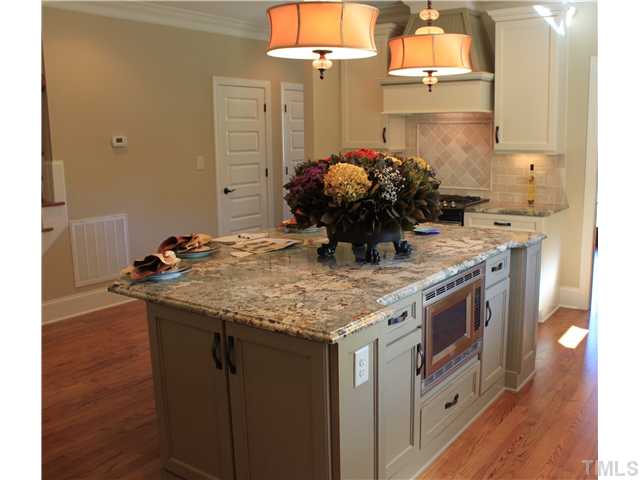 4909 Great Meadows Court Raleigh, NC 27609 - Photo 16 of 25 Center island with lots af cabinet space all round.