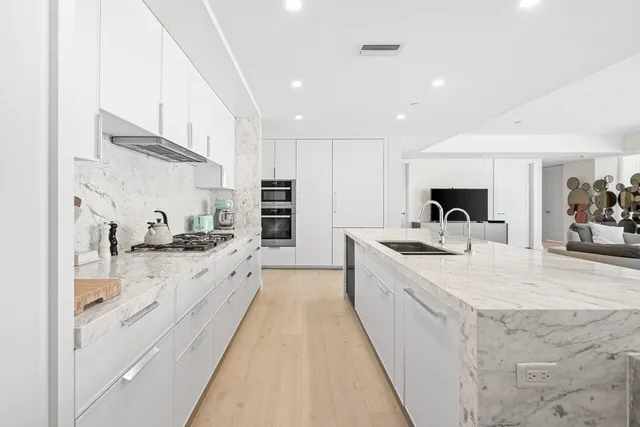 a spacious bedroom with a bed and a large window