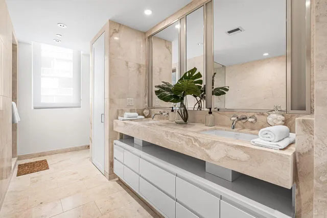 a bedroom with a large bed and a large window