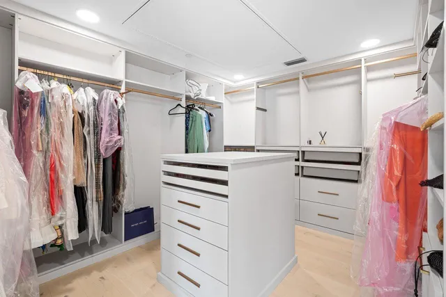 a bathroom with a white tub and a potted plant