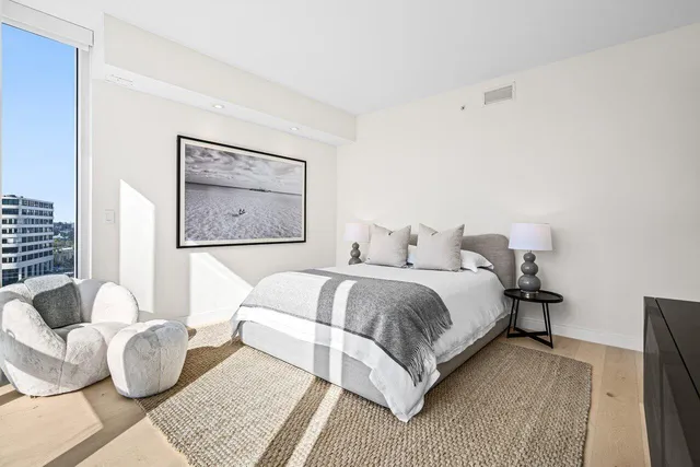 a bathroom with a granite countertop toilet and a sink