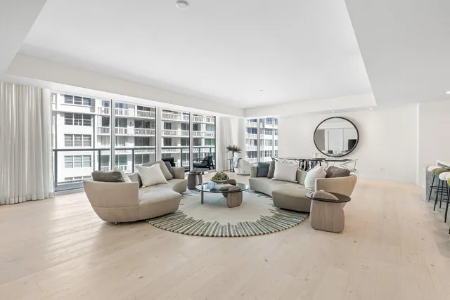a large kitchen with kitchen island a dining table chairs and white stainless steel appliances