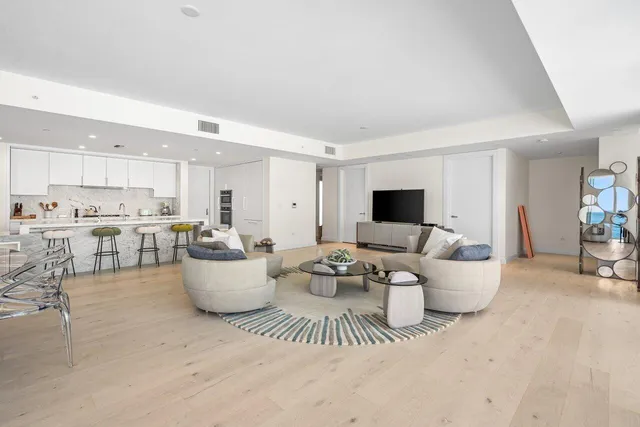 a kitchen with granite countertop kitchen island white cabinets and refrigerator