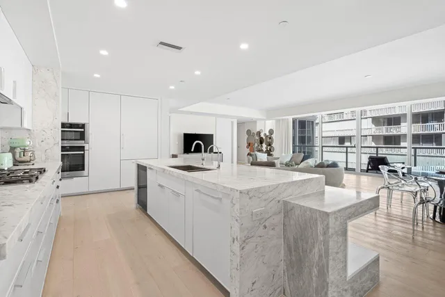 a bedroom with a large bed and a large window with outer view