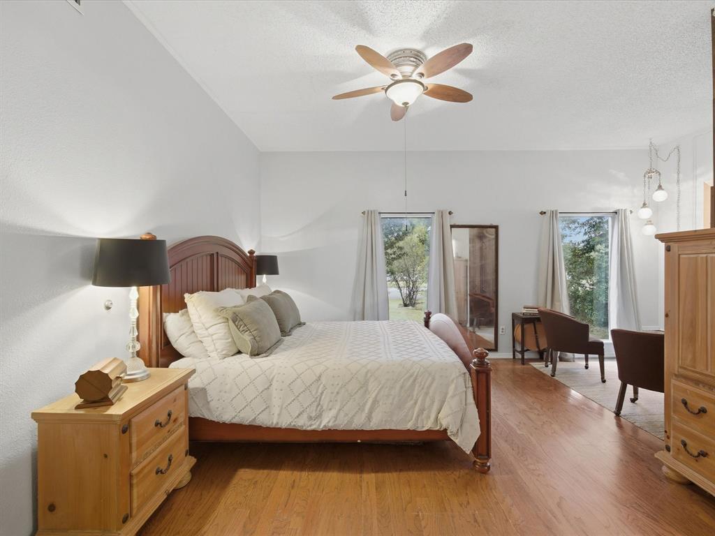 907 4th Street Graham, TX 76450 - Photo 13 of 34 a bedroom with a bed and wooden floor