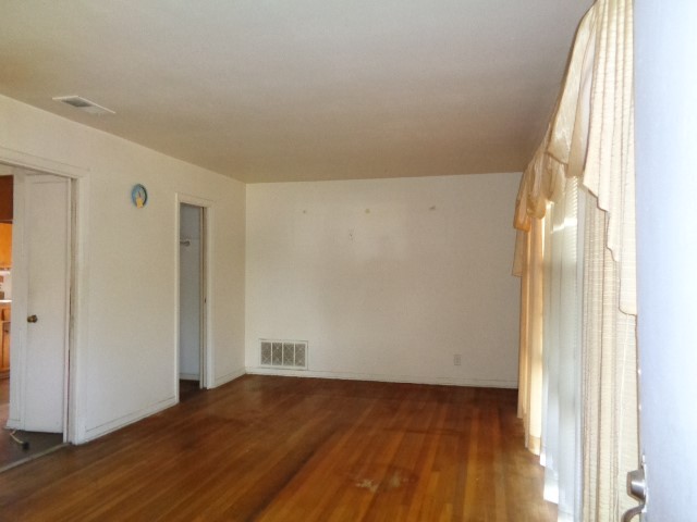 5614 Rue Street Houston, TX 77033 - Photo 2 of 18 a view of an empty room and wooden floor