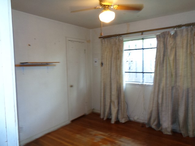 5614 Rue Street Houston, TX 77033 - Photo 10 of 18 a view of empty room with wooden floor and fan